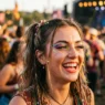 Woman at outdoor festival with bold colorful makeup in warm afternoon light