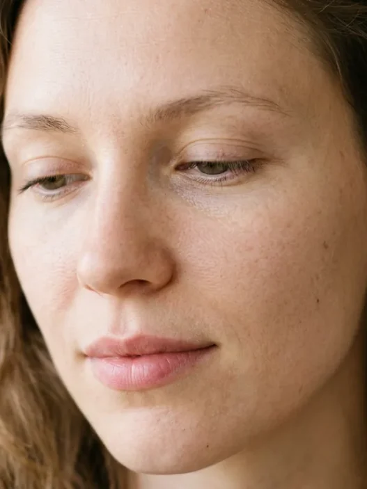 Woman with completely bare eyes and natural skin showing clean starting point for makeup