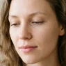 Woman with completely bare eyes and natural skin showing clean starting point for makeup