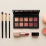 Professional makeup tools and products arranged in organized flat lay on clean white surface with bright lighting