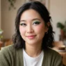 Woman with bold douyin-inspired makeup featuring graphic eyeliner and vibrant color combinations in natural lighting