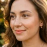 Woman's face showing heat-resistant makeup with natural glow in warm outdoor lighting