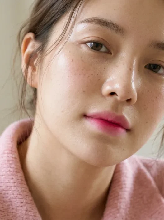 Woman wearing blurred pink gradient lips with deeper centre in soft daylight