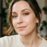 Woman with bronze eyeshadow and small kitten liner in soft daylight close-up