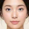 Woman with finished soft doll eye makeup showing round bright eyes and pink lips
