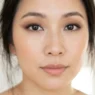 Woman with soft brown eyeshadow and thin liner showing lifted makeup on hooded eyes