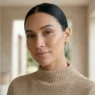 Woman with soft sculpted model makeup showing glowing skin and nude lips in daylight