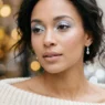 Woman with frosty silver eyeshadow and nude lips in soft warm light